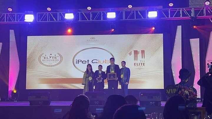 iPet Club team receiving an award on stage